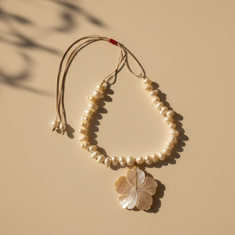 Isla Pearls: Limited quantities nylon adjustable necklace with freshwater pearls and a nacre hibiscus pendant.