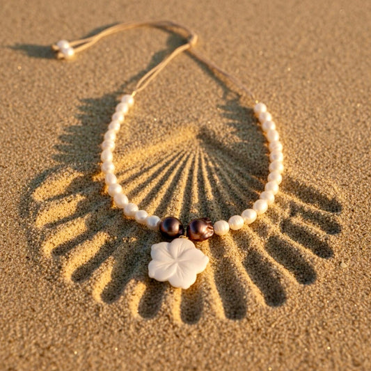 Isla Pearls: Limited quantities nylon adjustable necklace with freshwater pearls and two baroque copper pearls surrounding a small nacre hibiscus pendant.