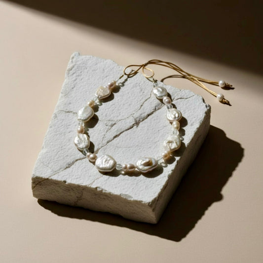 Bask in the gentle warmth of the Sun-Kissed Glow necklace, where the soft peach baroque coin pearls meet luminous peach freshwater pearls and sparkling clear quartz beads.