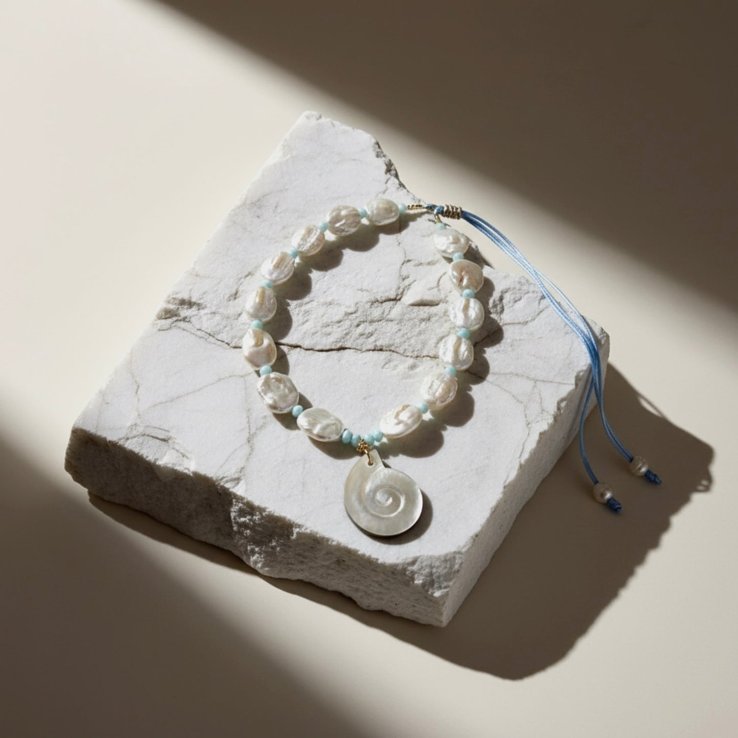 Ocean Muse – Azure captures the radiant clarity of open skies meeting endless sea. This luminous necklace features organically shaped baroque pearls, each one a testament to nature’s artistry, paired with light blue opal rondelles that shimmer with soft, tranquil tones reminiscent of gentle ocean waves.