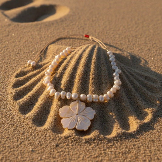 Isla Pearls: Limited quantities nylon adjustable  necklace with freshwater pearls and a nacre hibiscus pendant.