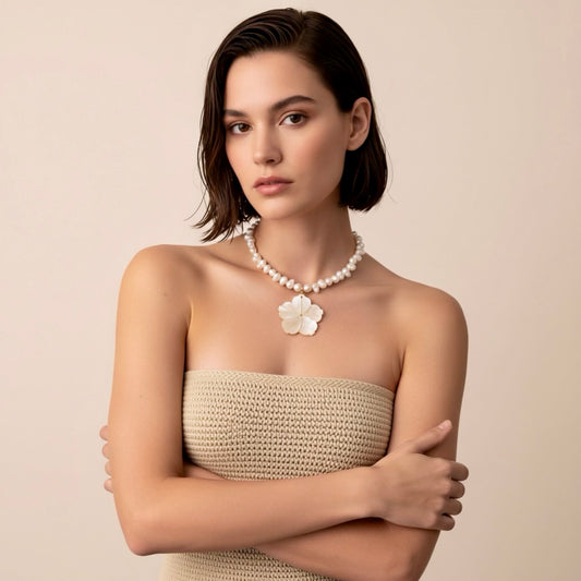 Isla Pearls: Limited quantities nylon adjustable  necklace with freshwater pearls and a nacre hibiscus pendant.