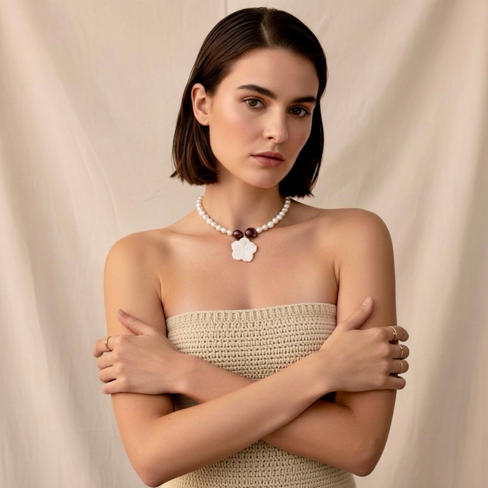 Isla Pearls: Limited quantities nylon adjustable necklace with freshwater pearls and two baroque copper pearls surrounding a small nacre hibiscus pendant.