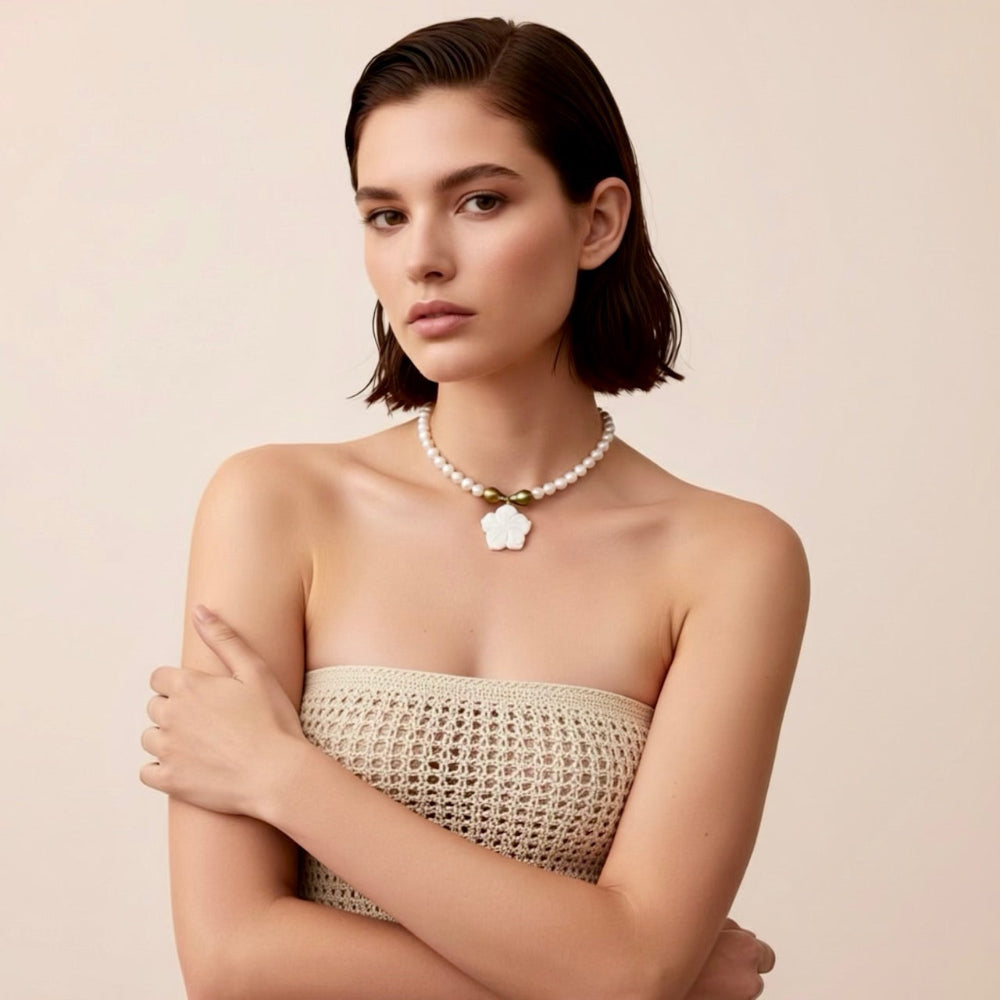 Isla Pearls: Limited quantities nylon adjustable necklace with freshwater pearls and two baroque emerald-lime pearls surrounding a small nacre hibiscus pendant.