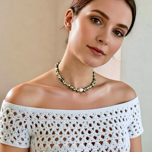 Isla Pearls: Limited quantities nylon adjustable necklace with green baroque pearls and freshwater pearls surrounding a white baroque pearl.