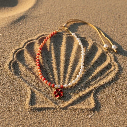 Handcrafted adjustable necklace with tangerine shell rondelles, beige stones, freshwater pearls and a tangerine-red stainless steel hibiscus flower pendant.