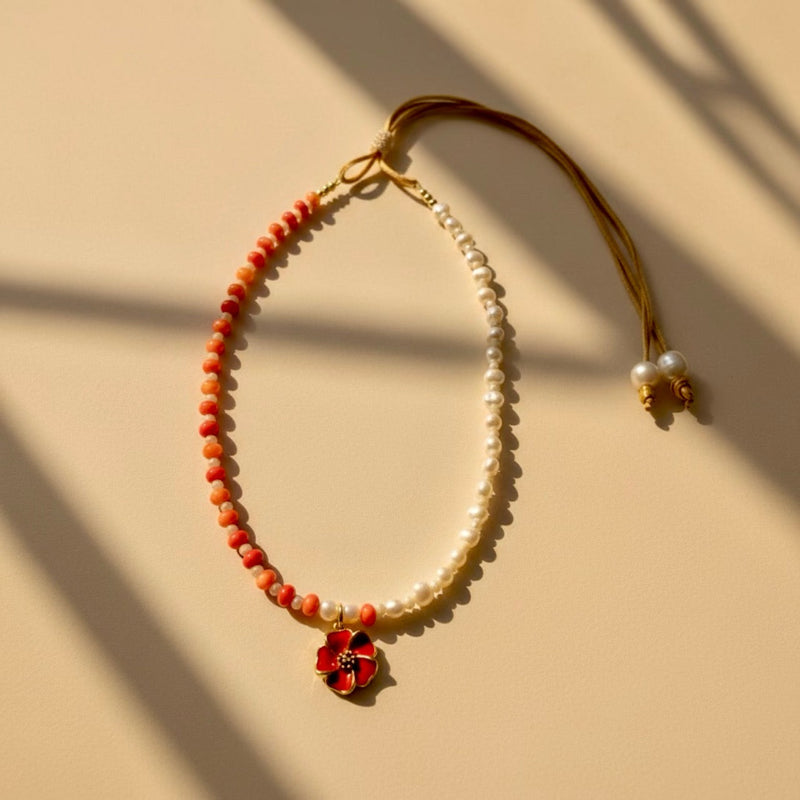 Handcrafted adjustable necklace with tangerine shell rondelles, beige stones, freshwater pearls and a tangerine-red stainless steel hibiscus flower pendant.