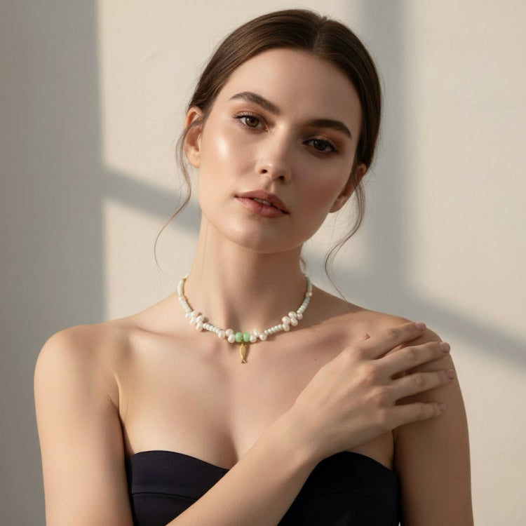 A tranquil, ocean-inspired necklace featuring mint-green shell rondelles and mint-green stones with luminous freshwater pearls. 