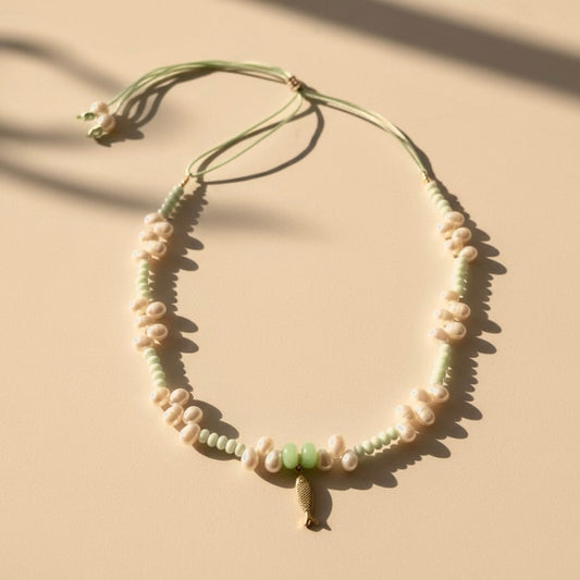 A tranquil, ocean-inspired necklace featuring mint-green shell rondelles and mint-green stones with luminous freshwater pearls. 