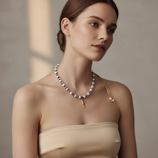 Dive into the Blue Lagoon, a serene blend of freshwater pearls, sparkling clear beads, and vibrant royal blue accents that inspire confidence and tranquility. A stainless steel fish pendant adds a marine touch and represents adaptability and the flow of life.