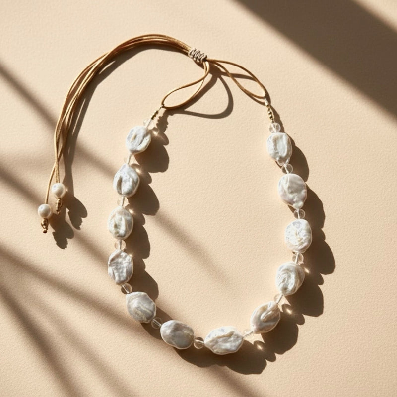 Seafoam Mist pairs clear quartz beads known for clarity, healing, and amplifying positive energy, with the unique beauty of baroque coin pearls, symbol of prosperity.