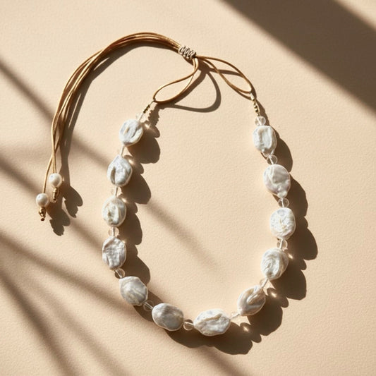 Seafoam Mist pairs clear quartz beads known for clarity, healing, and amplifying positive energy, with the unique beauty of baroque coin pearls, symbol of prosperity.