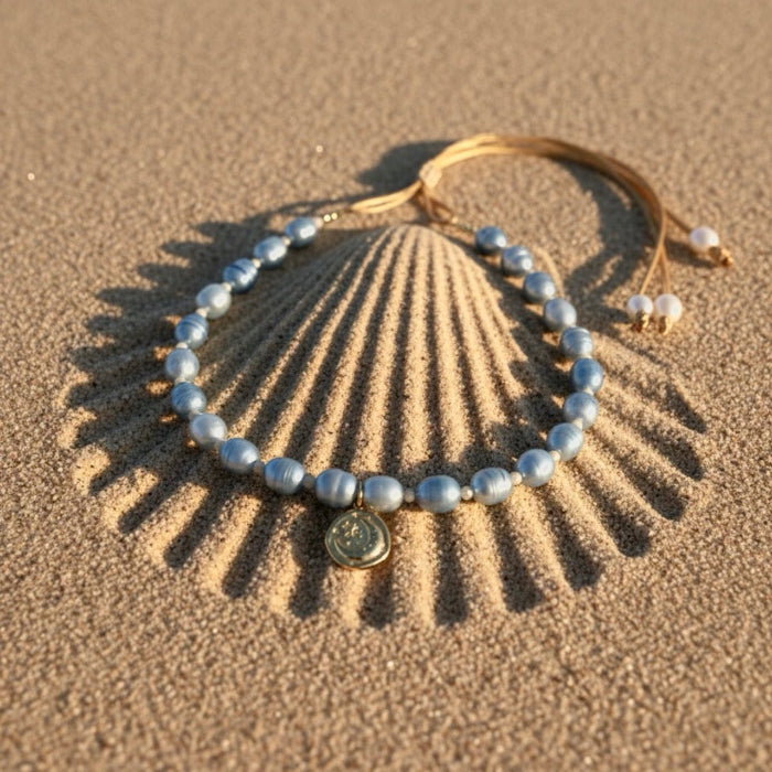 The Blue Moon adjustable necklace captures serenity and hope with blue freshwater pearls - symbols of tranquility and calm - gently linked by warm beige beads that embody balance and connection to the earth. 