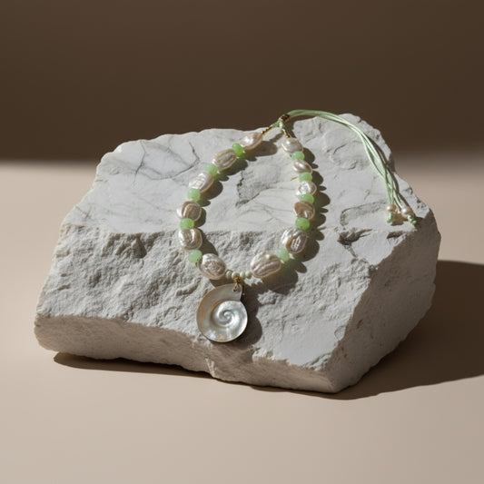 Ocean Muse – Mist Green evokes the tranquil hush of seafoam drifting along a quiet shore. This serene necklace pairs luminous baroque pearls—each one naturally unique—with soft green opal rondelles that shimmer with subtle, misty hues reminiscent of ocean waters at dawn.