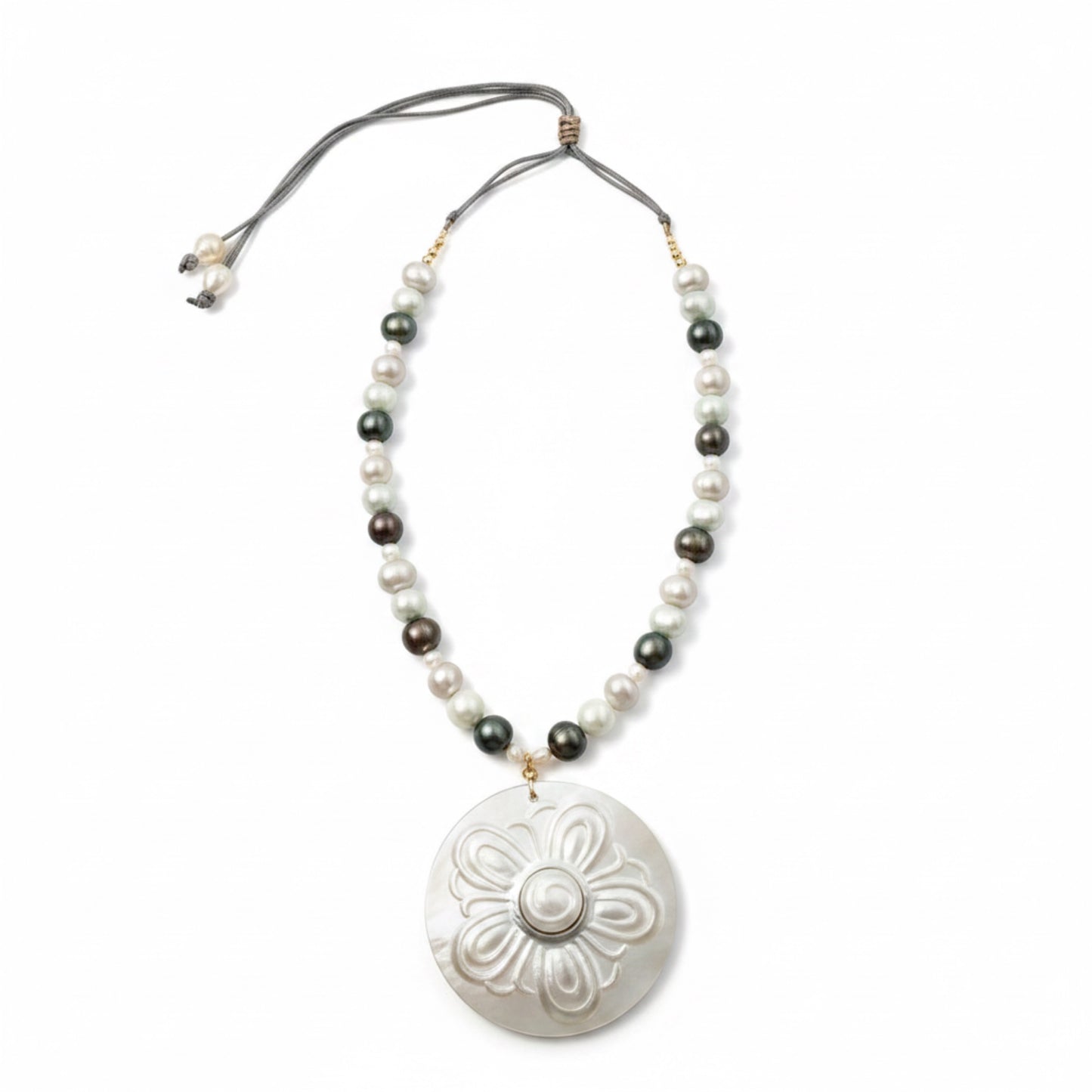 Nacre Bloom is a celebration of nature’s quiet elegance and the luminous beauty of the sea. This enchanting necklace brings together freshwater pearls in soft white, silvery gray, and delicate light blue tones, creating a gentle harmony of color that feels both modern and timeless.