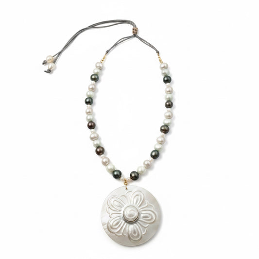 Nacre Bloom is a celebration of nature’s quiet elegance and the luminous beauty of the sea. This enchanting necklace brings together freshwater pearls in soft white, silvery gray, and delicate light blue tones, creating a gentle harmony of color that feels both modern and timeless.