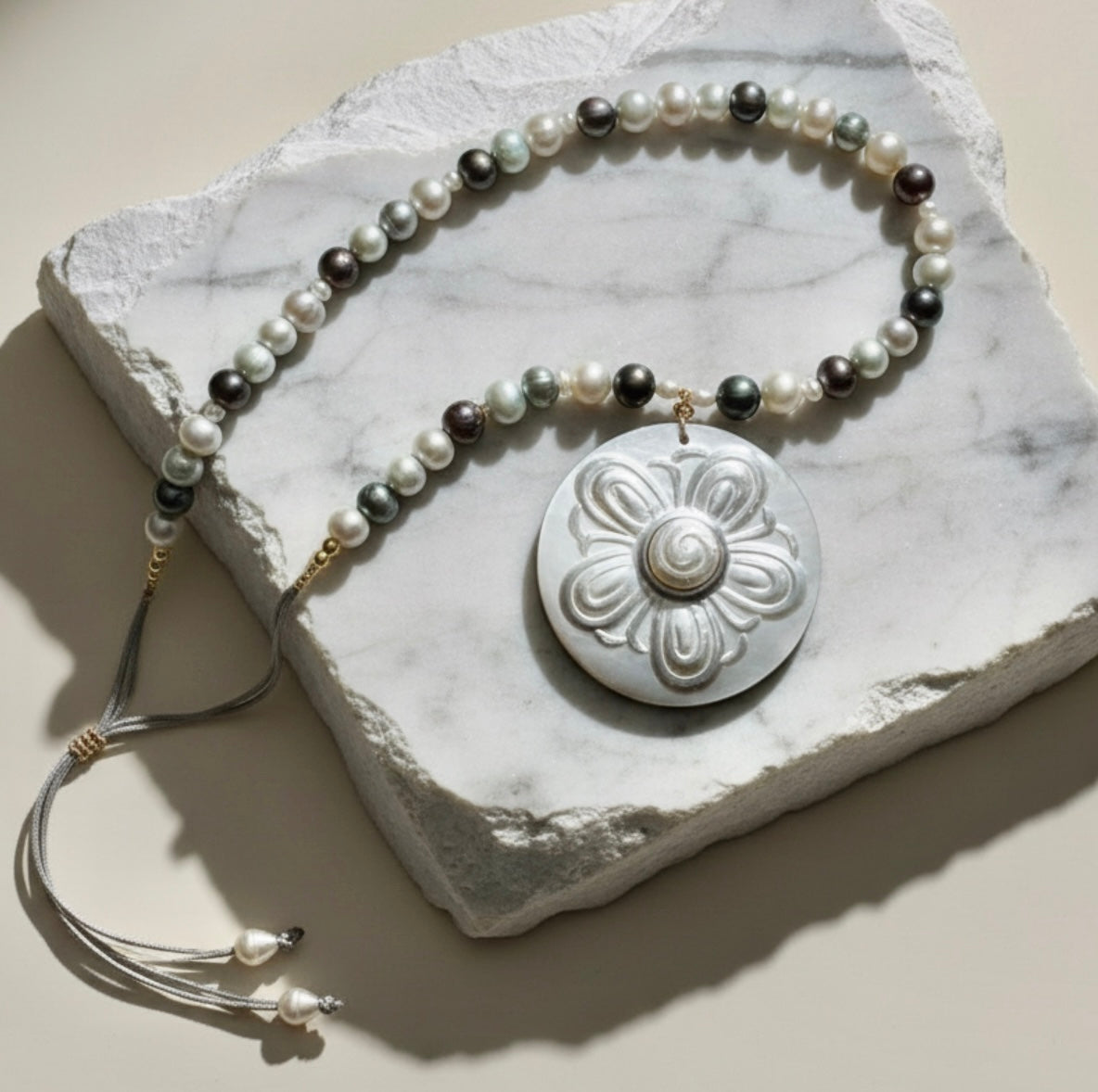 Nacre Bloom is a celebration of nature’s quiet elegance and the luminous beauty of the sea. This enchanting necklace brings together freshwater pearls in soft white, silvery gray, and delicate light blue tones, creating a gentle harmony of color that feels both modern and timeless.