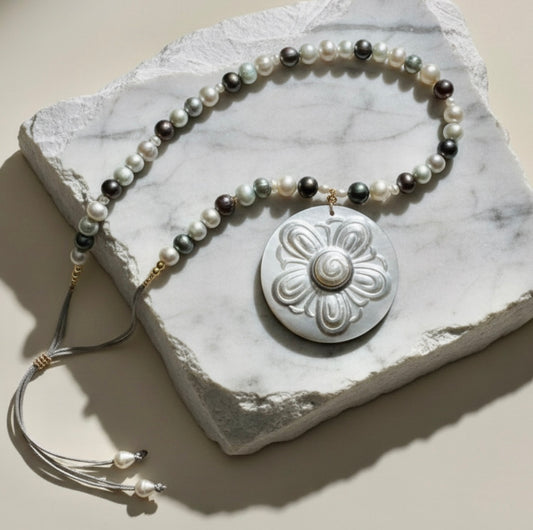 Nacre Bloom is a celebration of nature’s quiet elegance and the luminous beauty of the sea. This enchanting necklace brings together freshwater pearls in soft white, silvery gray, and delicate light blue tones, creating a gentle harmony of color that feels both modern and timeless.