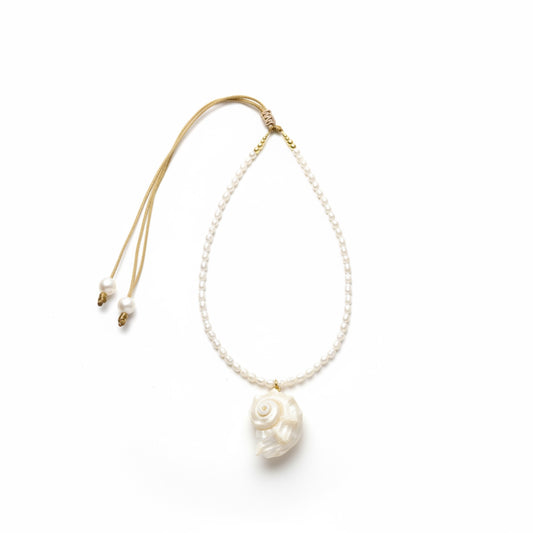 Pearl necklace with a shell pendant on a white background