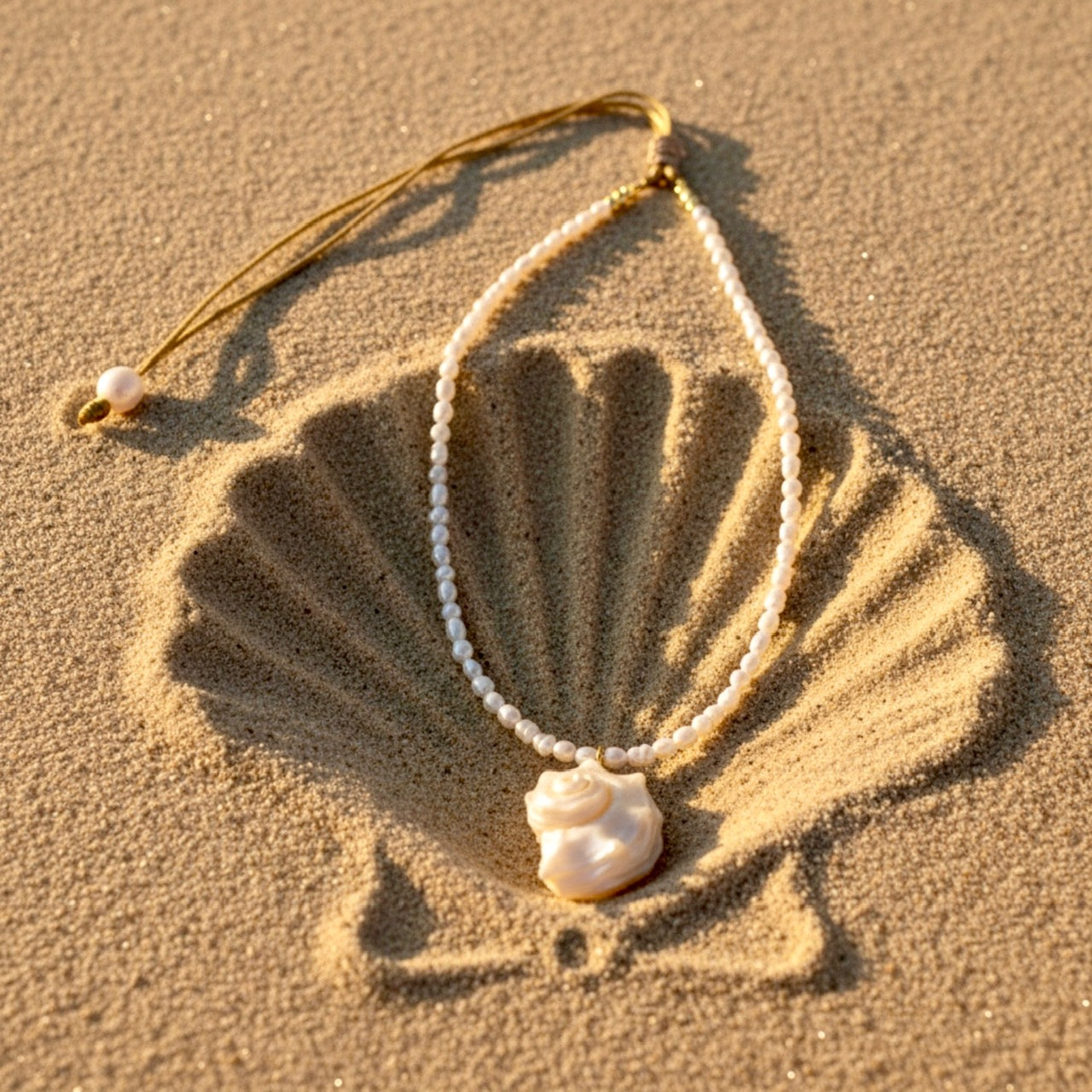 Ocean Whisper is a delicate, ocean-inspired necklace that captures the quiet magic of the sea. Strung with luminous freshwater mini rice pearls. At its center rests a graceful conch shell pendant, evoking the soothing rhythm of the tide and the timeless beauty of coastal shores.