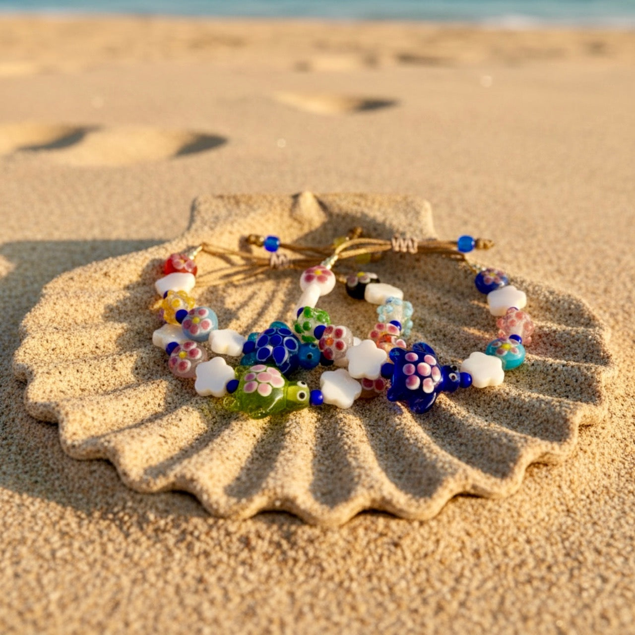 Colorful beaded bracelet on a large shell with a beach background