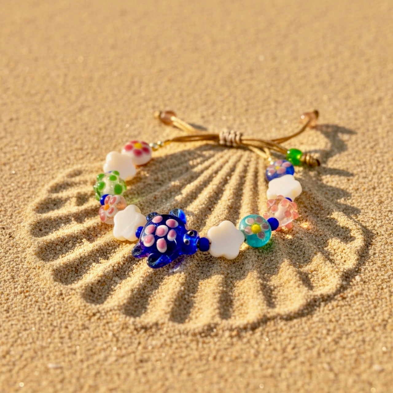 Colorful beaded bracelet on a sand background