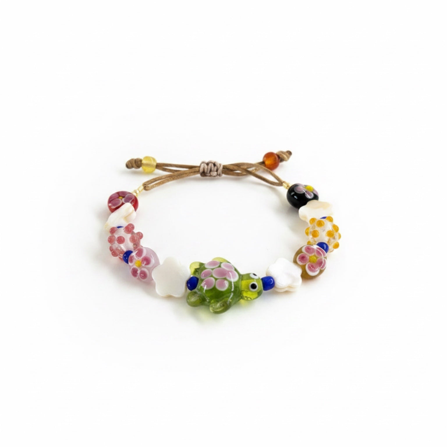 Bracelet with colorful beads and a turtle charm on a white background