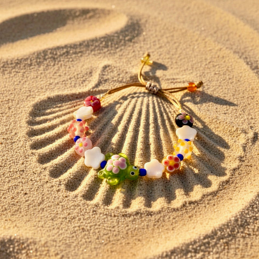 Colorful beaded bracelet on a sand background