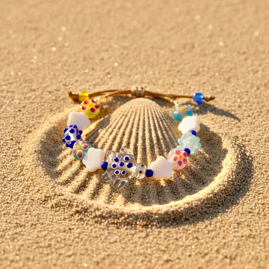Colorful beaded bracelet on a sand background