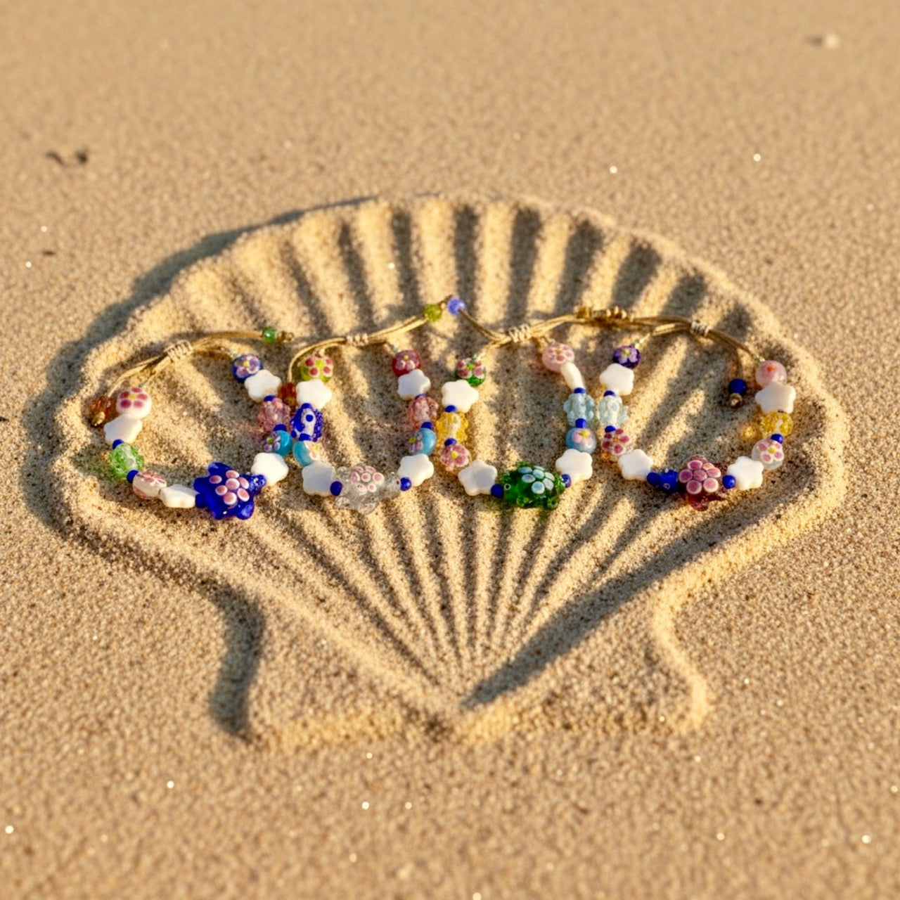 Colorful beaded bracelet on a shell drawn in sand