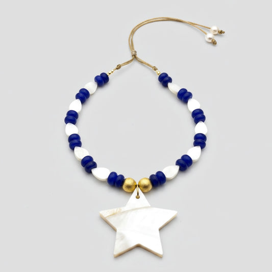 Necklace with blue, white, and gold beads and a star-shaped pendant on a light gray background
