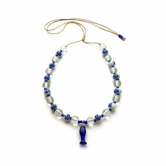 Necklace with blue and clear beads on a white background
