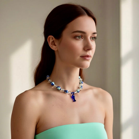 Woman wearing a blue and silver necklace against a neutral background